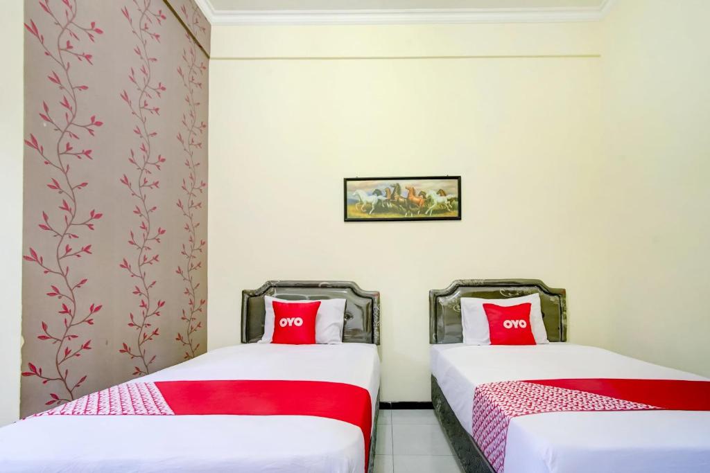Postel nebo postele na pokoji v ubytování Super OYO Capital O 90151 Guest House 180