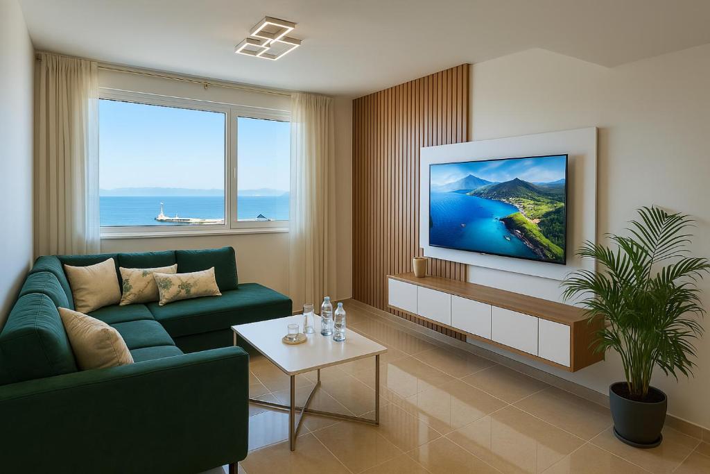 a living room with a green couch and a tv at Tanger City Center Residences Suites & sea view in Tangier