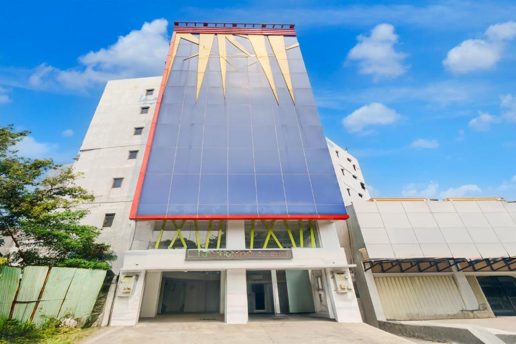 a tall building with a tower on top of it at Townhouse Oak Ancol in Jakarta