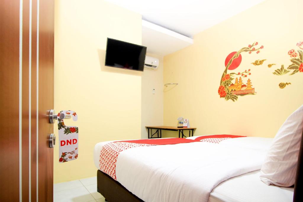 Postel nebo postele na pokoji v ubytování Super OYO Capital O 217 A1 Hotel