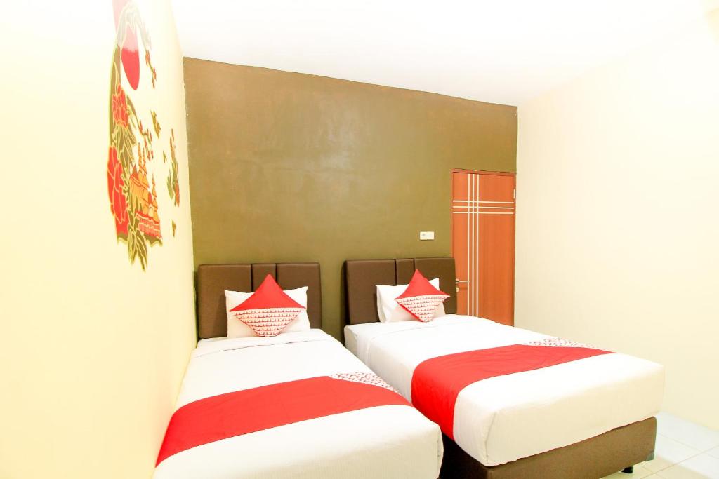 Postel nebo postele na pokoji v ubytování Super OYO Capital O 217 A1 Hotel