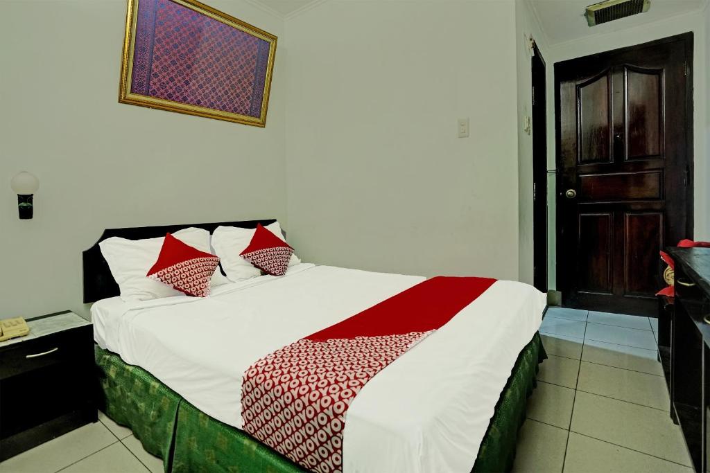 Postel nebo postele na pokoji v ubytování SUPER OYO 91805 Hotel Wisma Bari