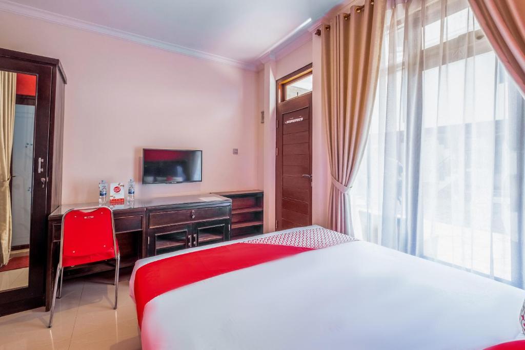 Postel nebo postele na pokoji v ubytování OYO Collection O 1032 Rahayu Residence Syariah