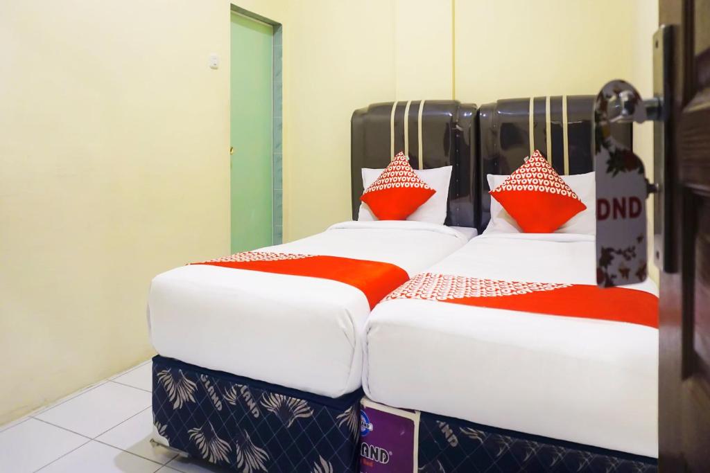 Postel nebo postele na pokoji v ubytování OYO 1192 Lotus Inn