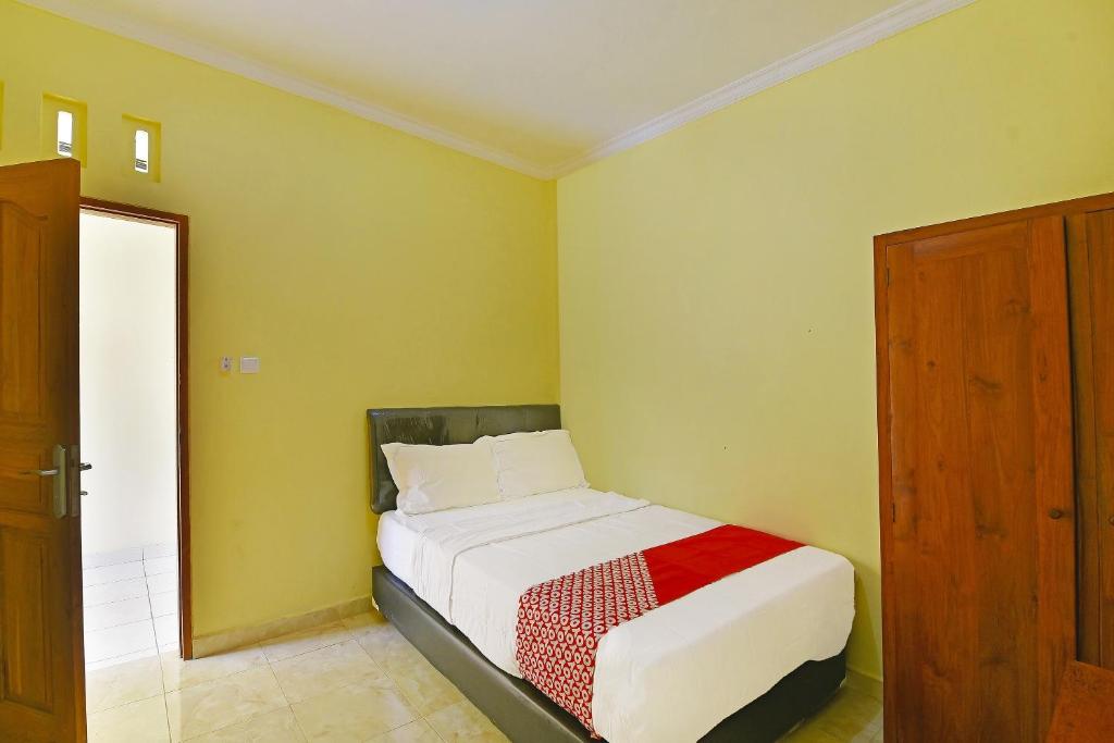 Postel nebo postele na pokoji v ubytování OYO Life 90675 Ld Residence