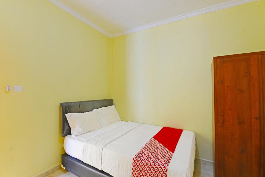 Postel nebo postele na pokoji v ubytování OYO Life 90675 Ld Residence