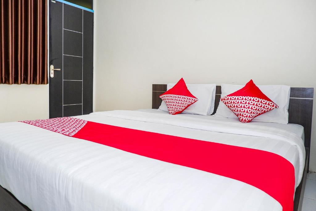 Postel nebo postele na pokoji v ubytování OYO 1217 Candi Residence