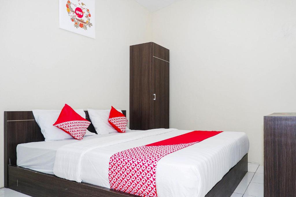 Postel nebo postele na pokoji v ubytování OYO 1217 Candi Residence