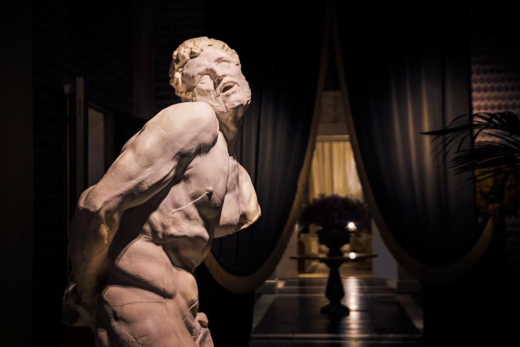 a statue of a bust of a man in a room at Hotel Van Cleef in Bruges