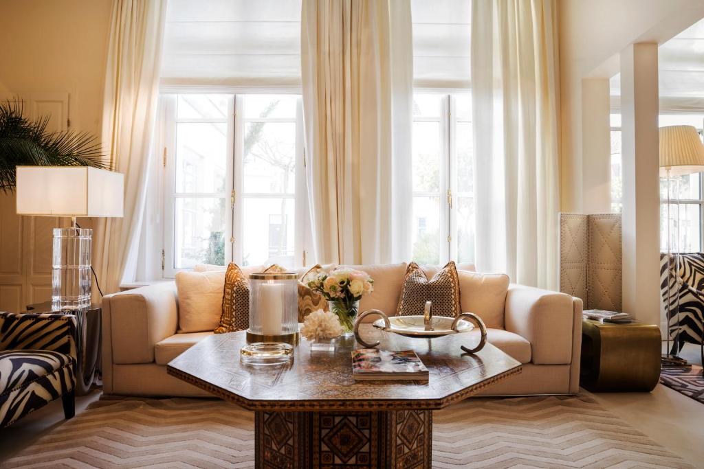 a living room with a couch and a table at Hotel Van Cleef in Bruges