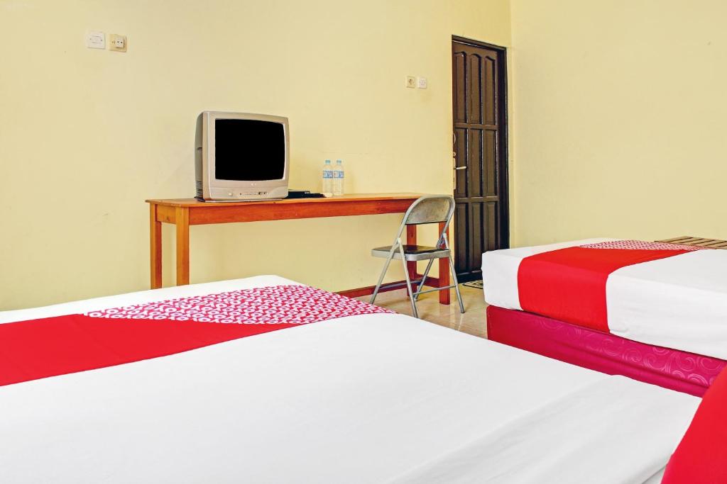 Postel nebo postele na pokoji v ubytování OYO 90423 Hotel Aman