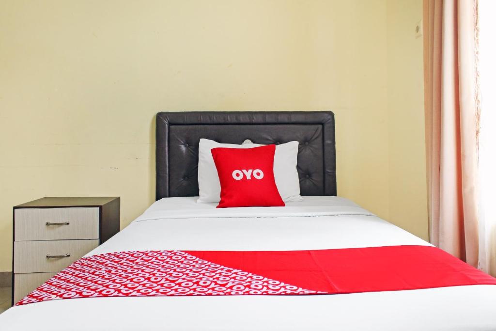 Postel nebo postele na pokoji v ubytování OYO 90423 Hotel Aman