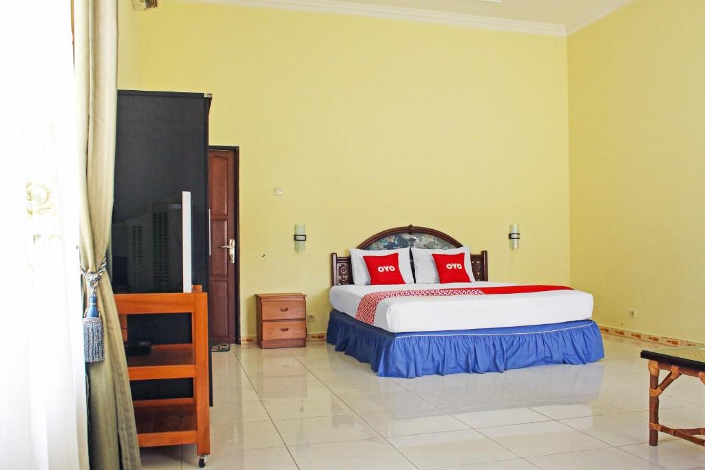 Postel nebo postele na pokoji v ubytování OYO 90423 Hotel Aman