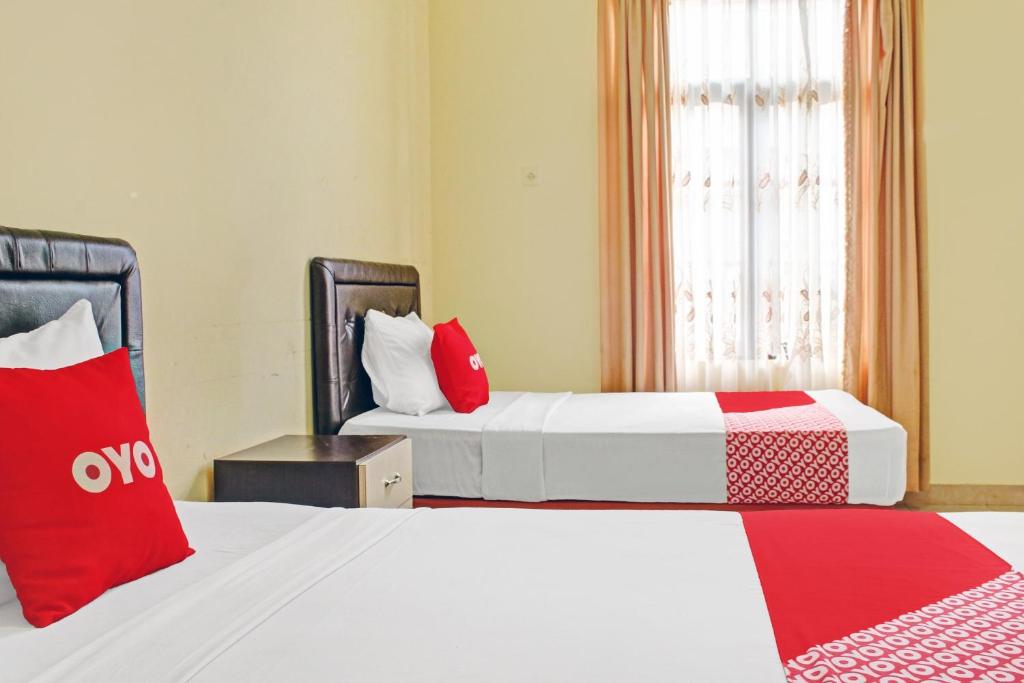 Postel nebo postele na pokoji v ubytování OYO 90423 Hotel Aman