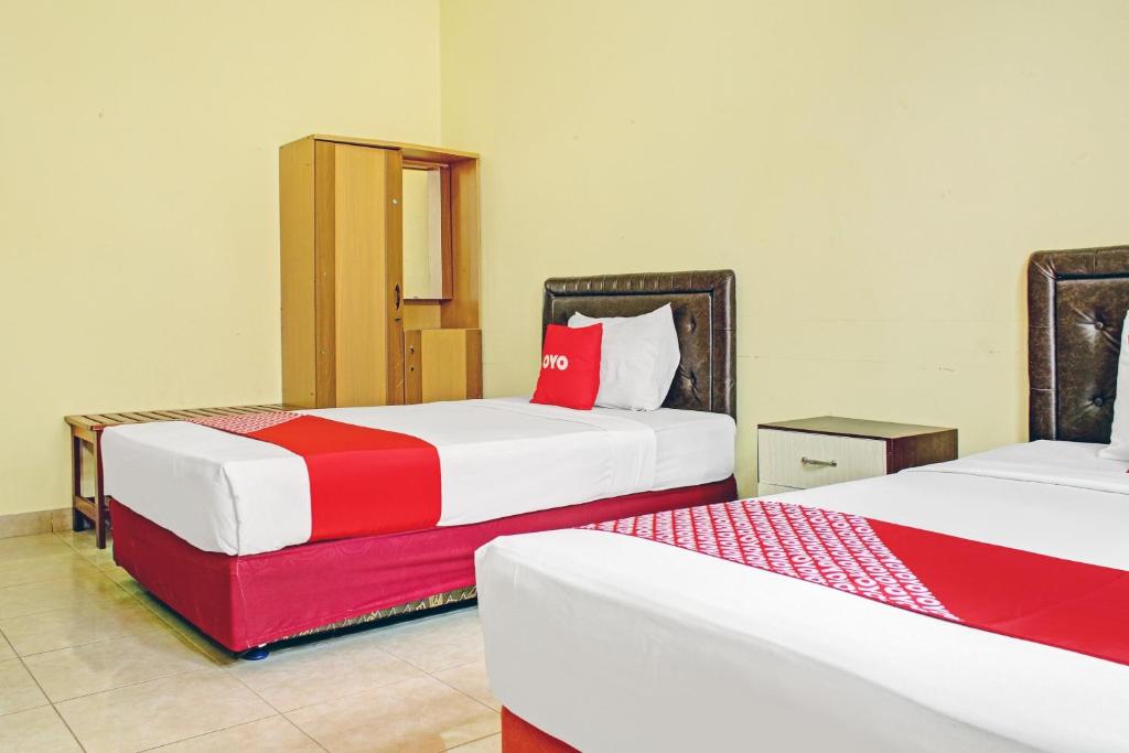 Postel nebo postele na pokoji v ubytování OYO 90423 Hotel Aman