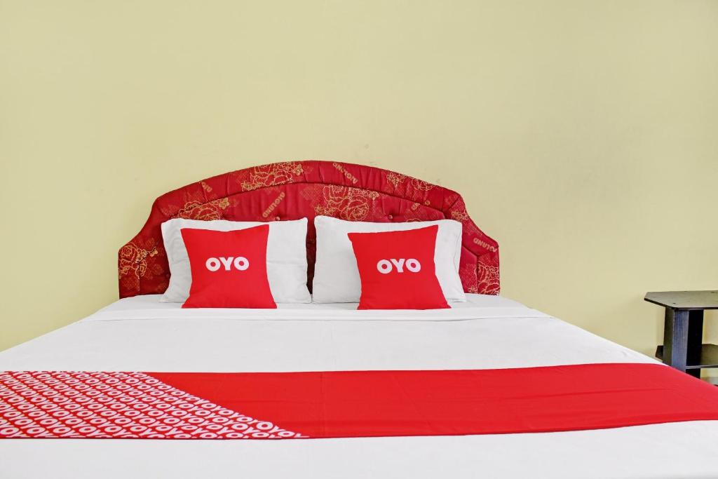 Postel nebo postele na pokoji v ubytování OYO 90423 Hotel Aman