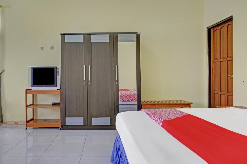 Postel nebo postele na pokoji v ubytování OYO 90423 Hotel Aman