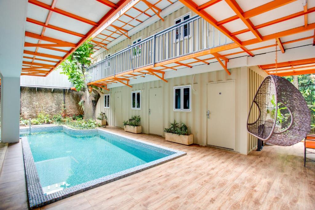 an indoor swimming pool in a house with an open ceiling at Capital O 3300 Nadjara Residence Syariah in Jakarta