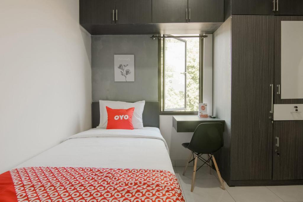 Postel nebo postele na pokoji v ubytování OYO 3826 Columbus Residence K11