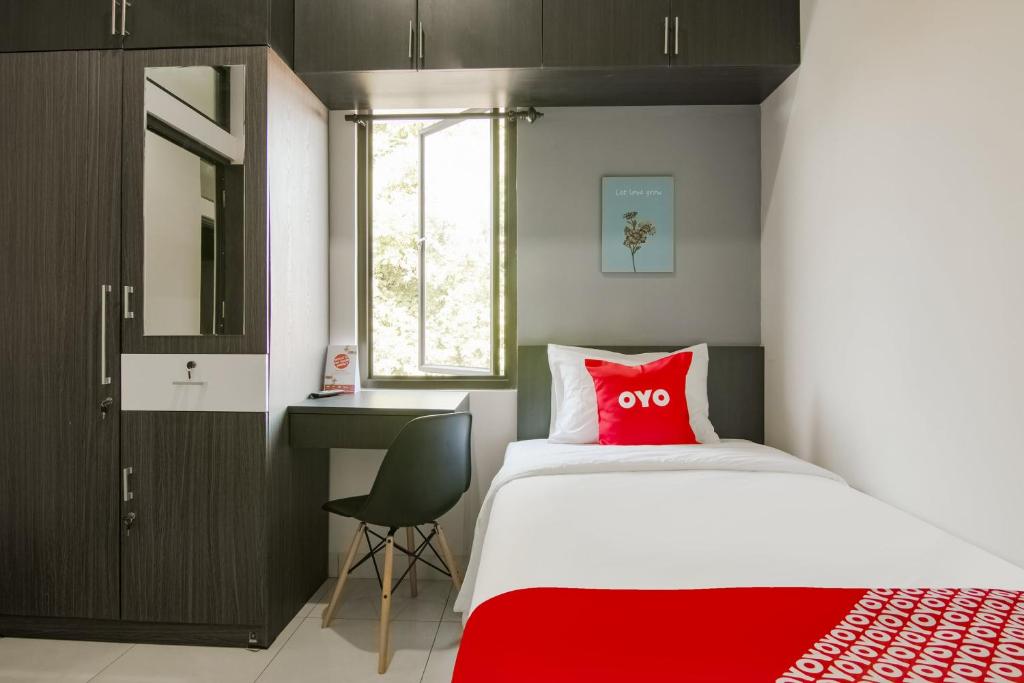 Postel nebo postele na pokoji v ubytování OYO 3826 Columbus Residence K11