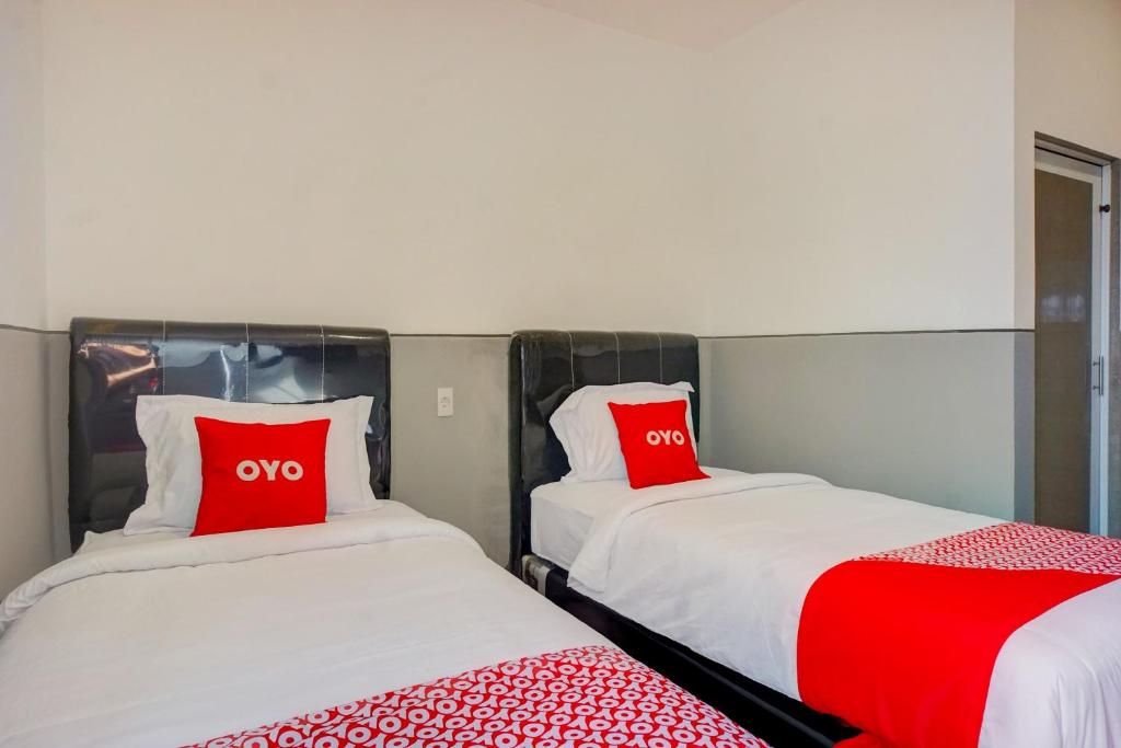 Postel nebo postele na pokoji v ubytování SUPER OYO 93064 Alhesa Residence