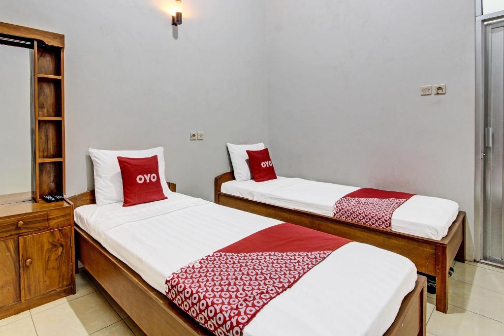 Postel nebo postele na pokoji v ubytování Super OYO 91748 Wisma Pkpri Purworejo