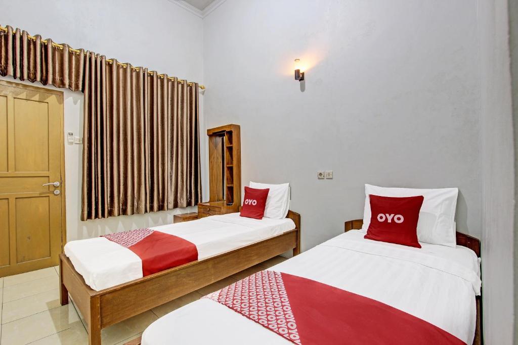 Postel nebo postele na pokoji v ubytování Super OYO 91748 Wisma Pkpri Purworejo