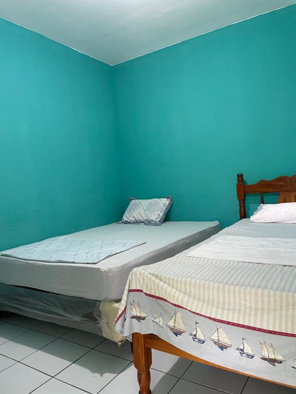Voodi või voodid majutusasutuse Hostal Isla Natal toas