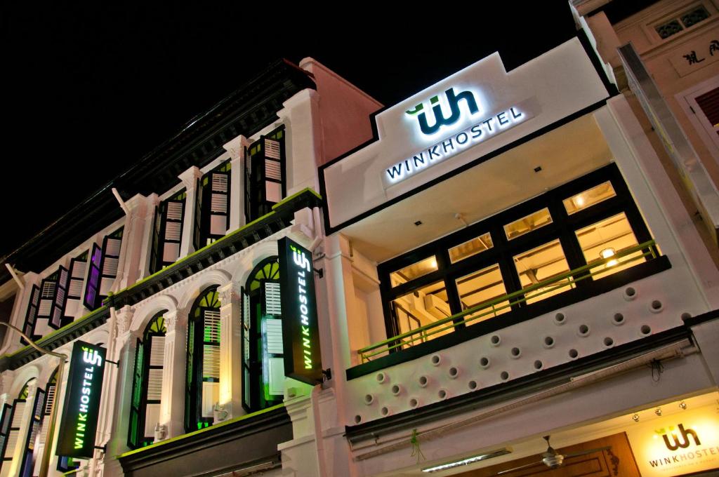 a building with a sign on the side of it at Wink at Mosque Street in Singapore