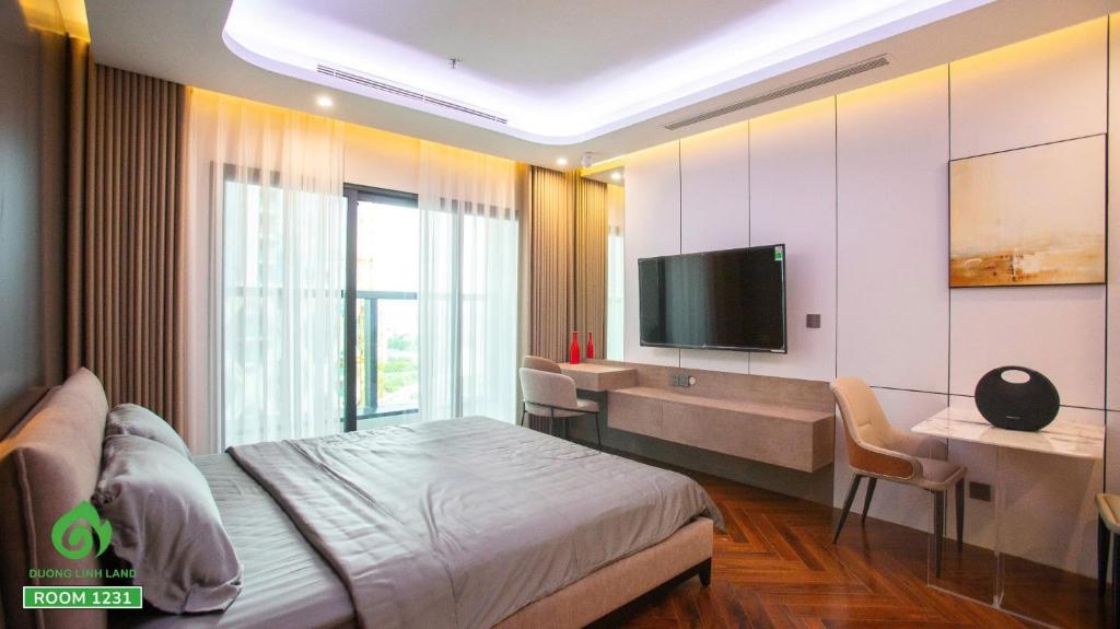 a bedroom with a bed and a desk and a television at Thuý Doji Diamond Apartment in Hai Phong