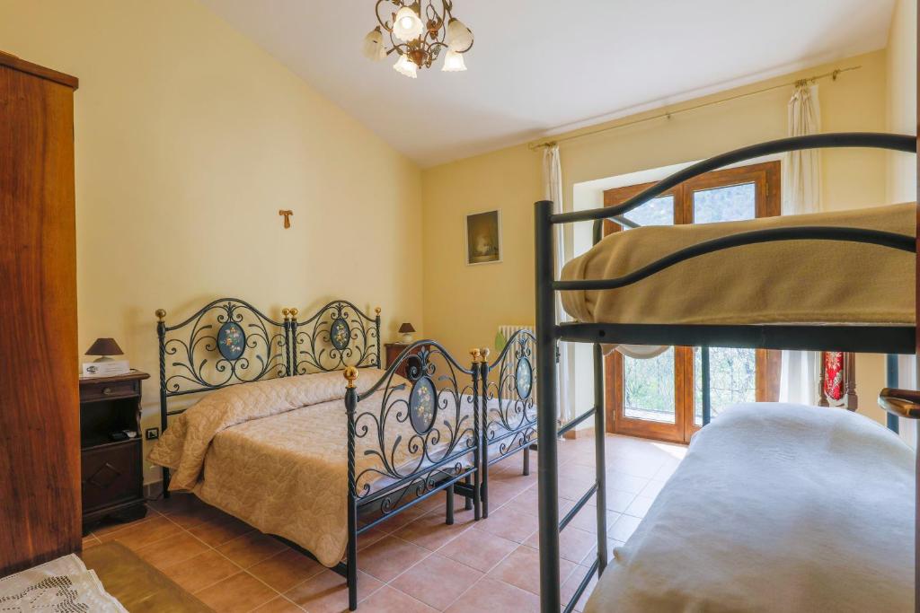 a bedroom with a bed and a bunk bed at Casa vacanze da Medardo in Gagliano Aterno
