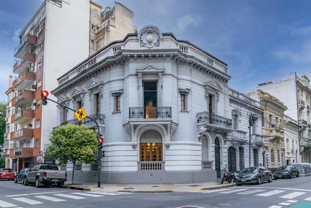 a white building on the corner of a street at Luxury mansion in Recoleta - Jacuzzi - Sauna - 40 people in Buenos Aires