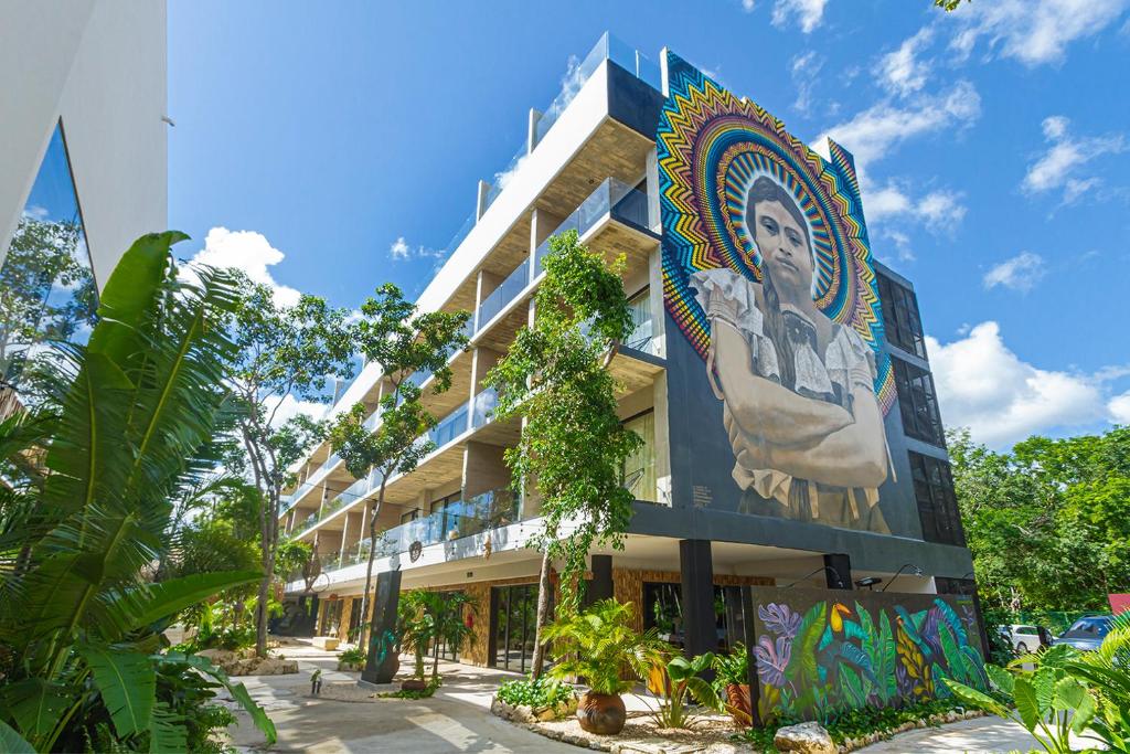 a building with a mural on the side of it at TUK Tulum Studios in Tulum
