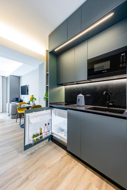 Kuchyň nebo kuchyňský kout v ubytování MH SUITES Plebiscito