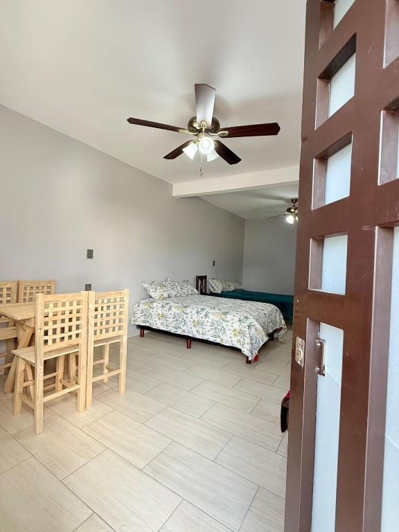 a bedroom with a bed and a ceiling fan at El Rinconcito Oaxaca - HiveNB in Santa Cruz Xoxocotlán