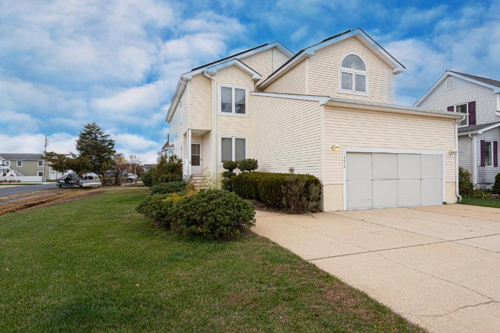a large white house with a white garage at Waterfront Home with OC Skyline Views in Ocean City