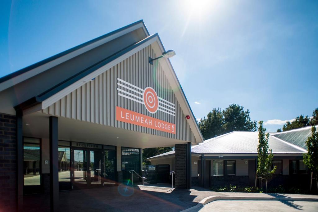 a building with a sign on the side of it at Leumeah Lodge in Canberra