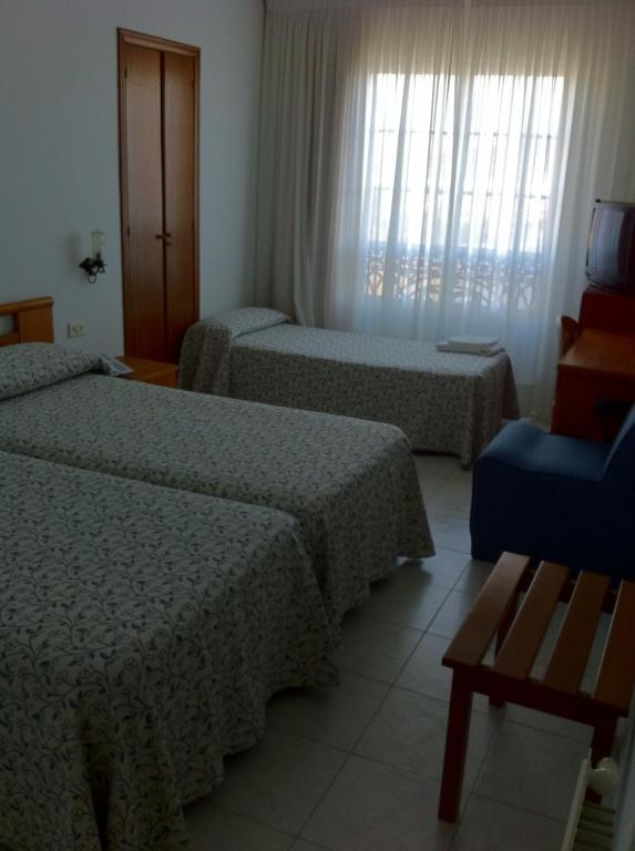 Łóżko lub łóżka w pokoju w obiekcie Hotel Pinzon