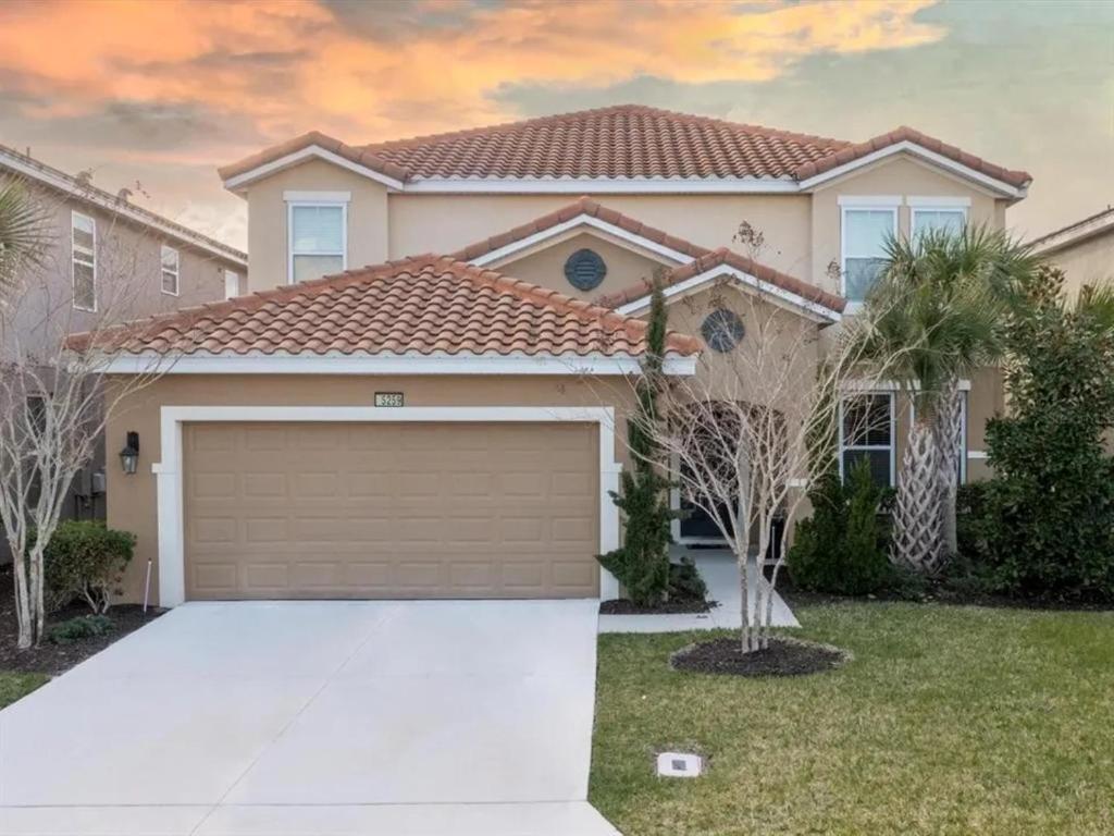 a house with a garage in front of it at 5259-6-WW-Pool&SPA Lazy River&Slides in Davenport