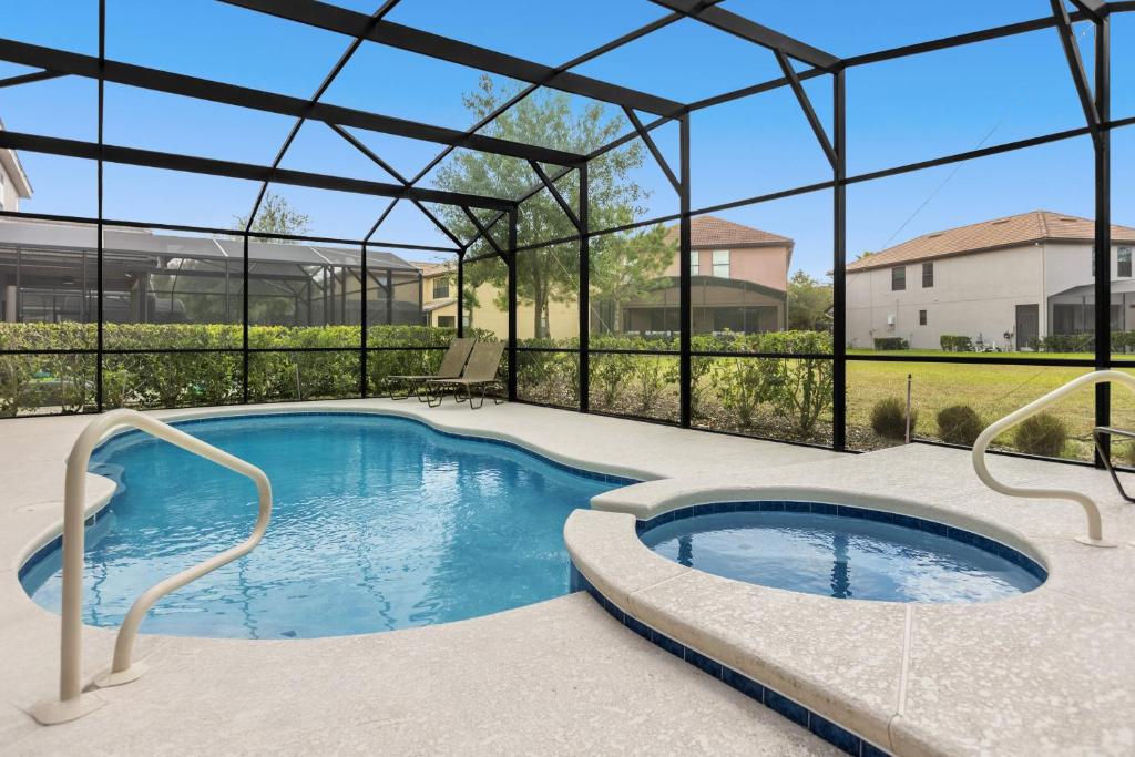 a large swimming pool with a pergola and a swimming pool at 5259-6-WW-Pool&SPA Lazy River&Slides in Davenport