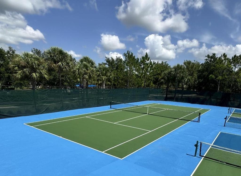 a tennis court with two tennis nets on it at 5259-6-WW-Pool&SPA Lazy River&Slides in Davenport