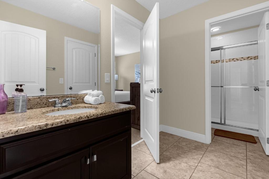 a bathroom with a sink and a shower at 5259-6-WW-Pool&SPA Lazy River&Slides in Davenport