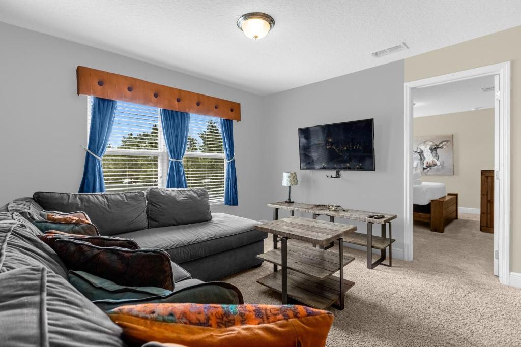 a living room with a couch and a table at 5259-6-WW-Pool&SPA Lazy River&Slides in Davenport