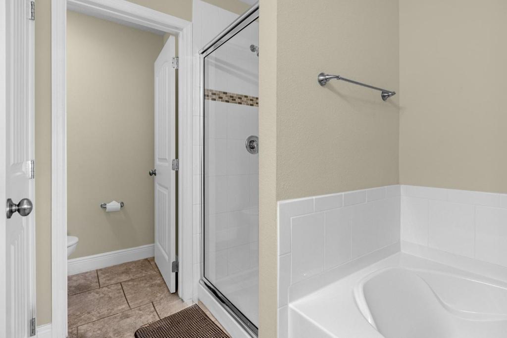 a white bathroom with a tub and a shower at 5259-6-WW-Pool&SPA Lazy River&Slides in Davenport