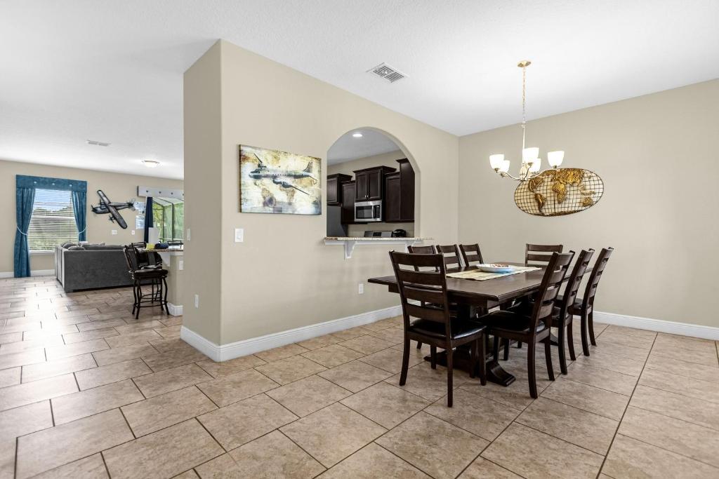 a dining room and living room with a table and chairs at 5259-6-WW-Pool&SPA Lazy River&Slides in Davenport