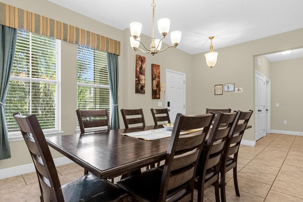 a dining room with a table and chairs at 5259-6-WW-Pool&SPA Lazy River&Slides in Davenport