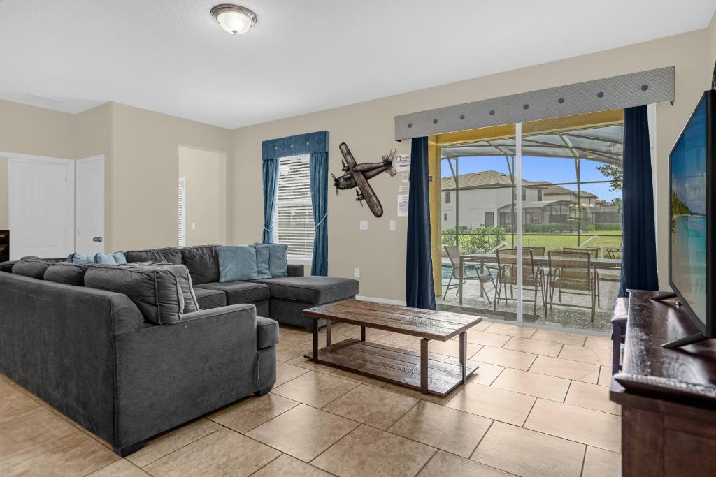 a living room with a couch and a table at 5259-6-WW-Pool&SPA Lazy River&Slides in Davenport