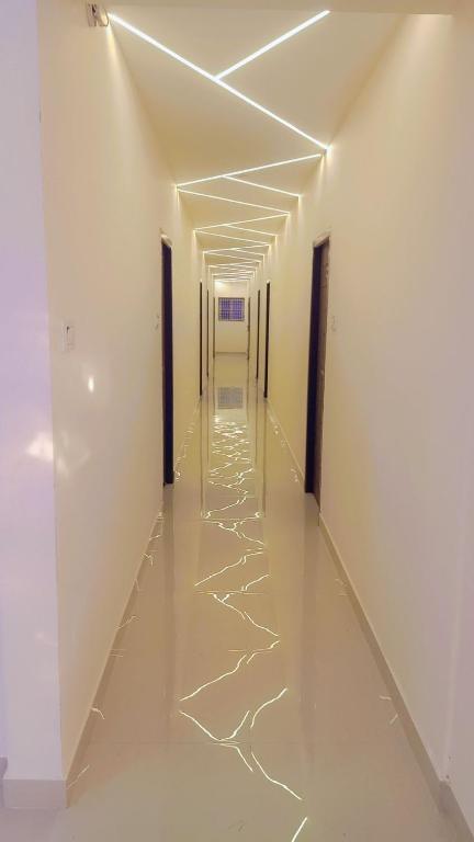 an empty hallway with white walls and white floors and ceilings at SSK Rooms in Gūduvāncheri