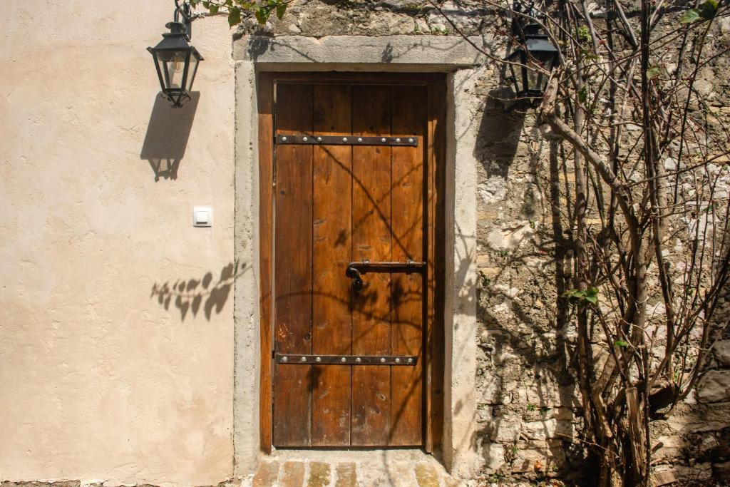 a wooden door on the side of a building at Krasospito 1850 - a Corfiot Wine House Reborn in Lefkimmi
