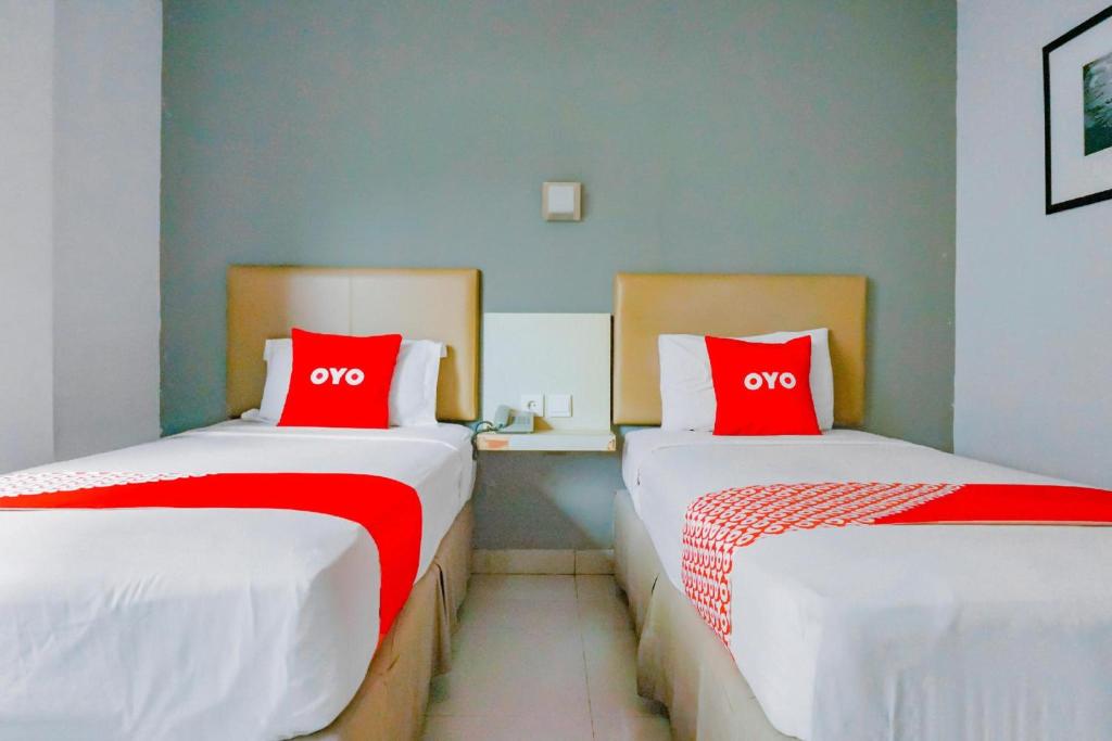 Postel nebo postele na pokoji v ubytování Collection O Hotel Antara